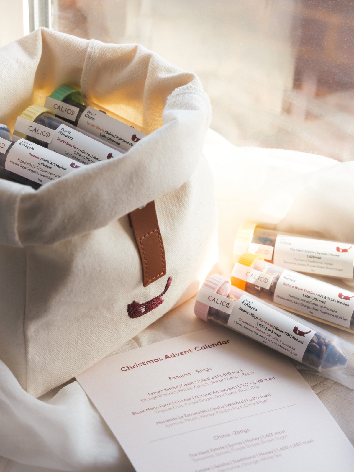 Calico Christmas Calendar coffee tubes and canvas bag in natural light